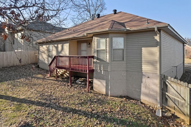 rear view of house with a wooden deck