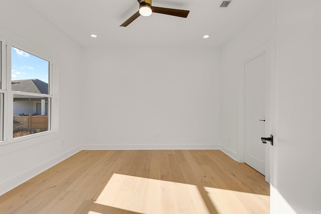 empty room with baseboards, recessed lighting, and light wood-style floors