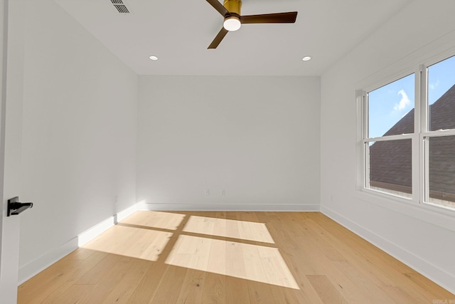 spare room with recessed lighting, light wood-type flooring, visible vents, and baseboards