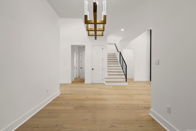 interior space with stairs, recessed lighting, baseboards, and light wood-style floors