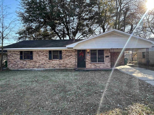 ranch-style house with a front yard and a carport