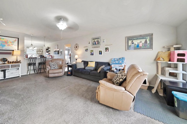 living room featuring ceiling fan, carpet floors, and vaulted ceiling