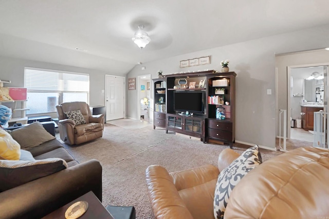 carpeted living room featuring vaulted ceiling and ceiling fan