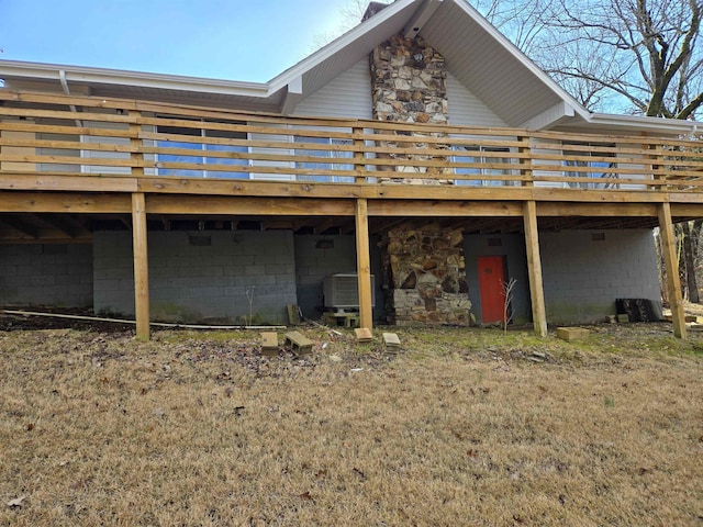 back of property featuring central AC unit and a deck