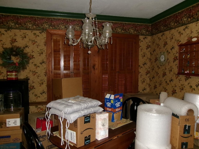 dining area with crown molding and a notable chandelier