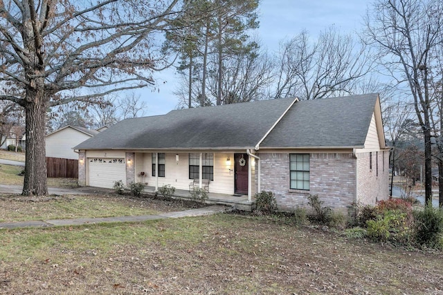 ranch-style home featuring covered porch and a garage