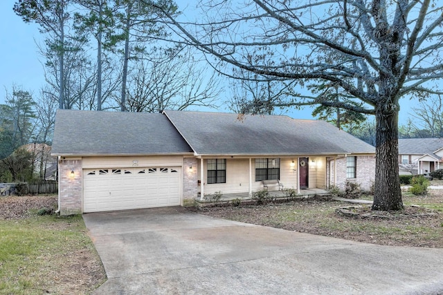 single story home with covered porch and a garage