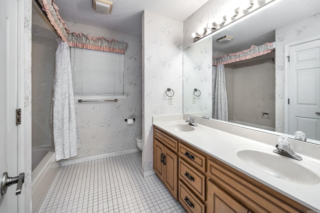 full bathroom featuring tile patterned floors, vanity, a textured ceiling, shower / tub combo with curtain, and toilet