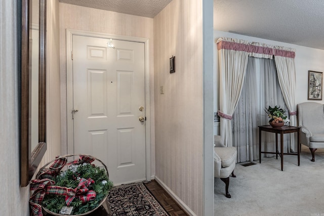 foyer entrance featuring a textured ceiling