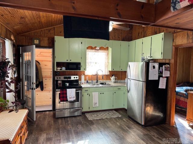 kitchen with ceiling fan, sink, green cabinets, vaulted ceiling, and appliances with stainless steel finishes