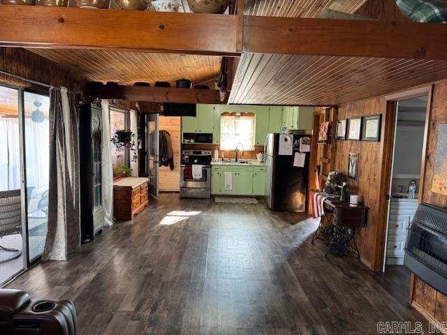 kitchen featuring stainless steel refrigerator, sink, green cabinetry, heating unit, and range