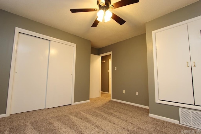 unfurnished bedroom featuring ceiling fan and light colored carpet