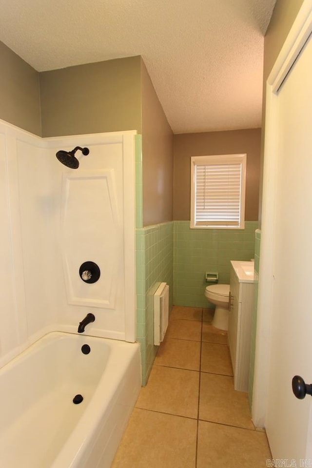 full bathroom with radiator, tile patterned flooring, toilet, shower / bathtub combination, and tile walls