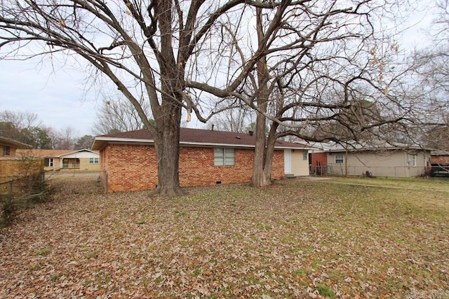 back of property with a lawn