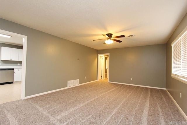 carpeted spare room with ceiling fan