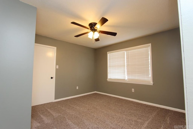 unfurnished room featuring ceiling fan and carpet floors