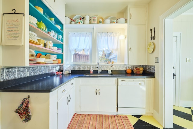 kitchen featuring dishwasher, white cabinets, and sink