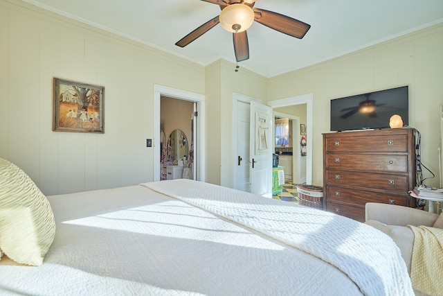 bedroom with ceiling fan, crown molding, ensuite bathroom, and wooden walls