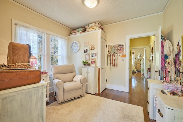 living area featuring crown molding, a textured ceiling, and hardwood / wood-style flooring