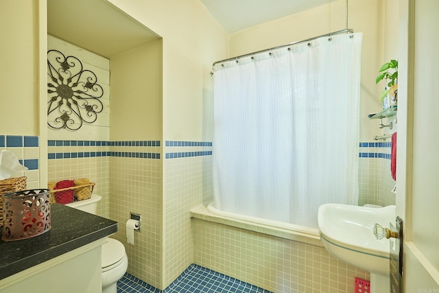 bathroom featuring shower / tub combo with curtain, tile patterned flooring, tile walls, and toilet