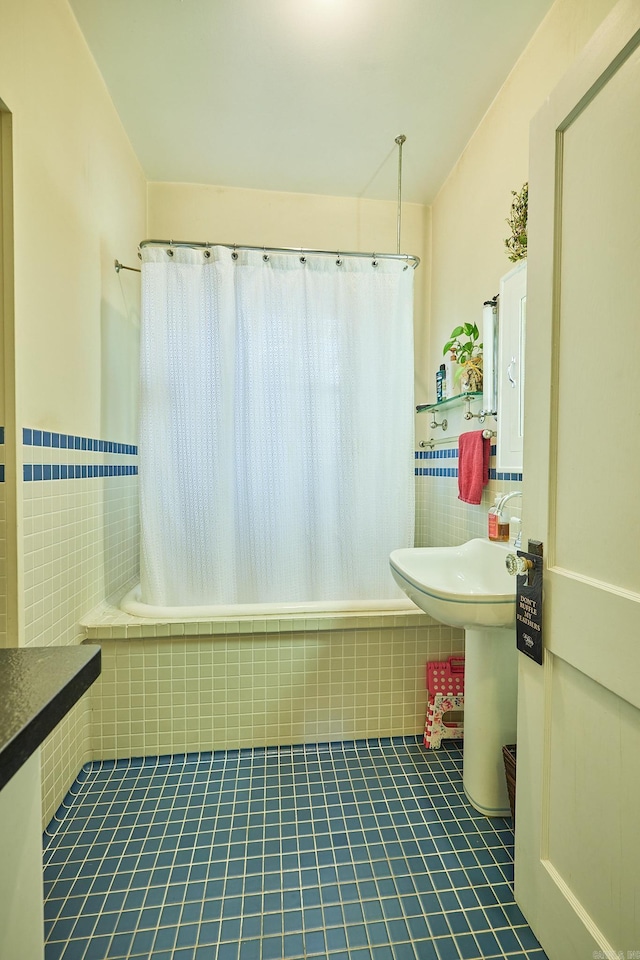 bathroom with tile patterned flooring and shower / bathtub combination with curtain