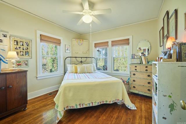 bedroom featuring multiple windows, ceiling fan, crown molding, and dark wood-type flooring