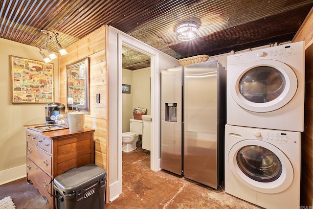 laundry area with stacked washer and clothes dryer