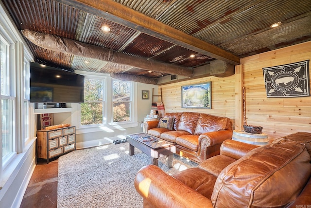 living room with wood walls, beamed ceiling, and wood ceiling