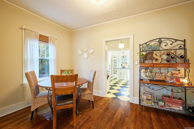 dining space featuring ornamental molding and dark wood-type flooring