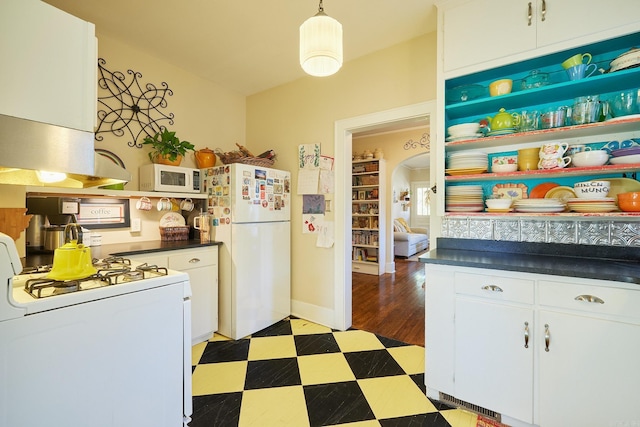 kitchen with exhaust hood, white cabinets, pendant lighting, and white appliances