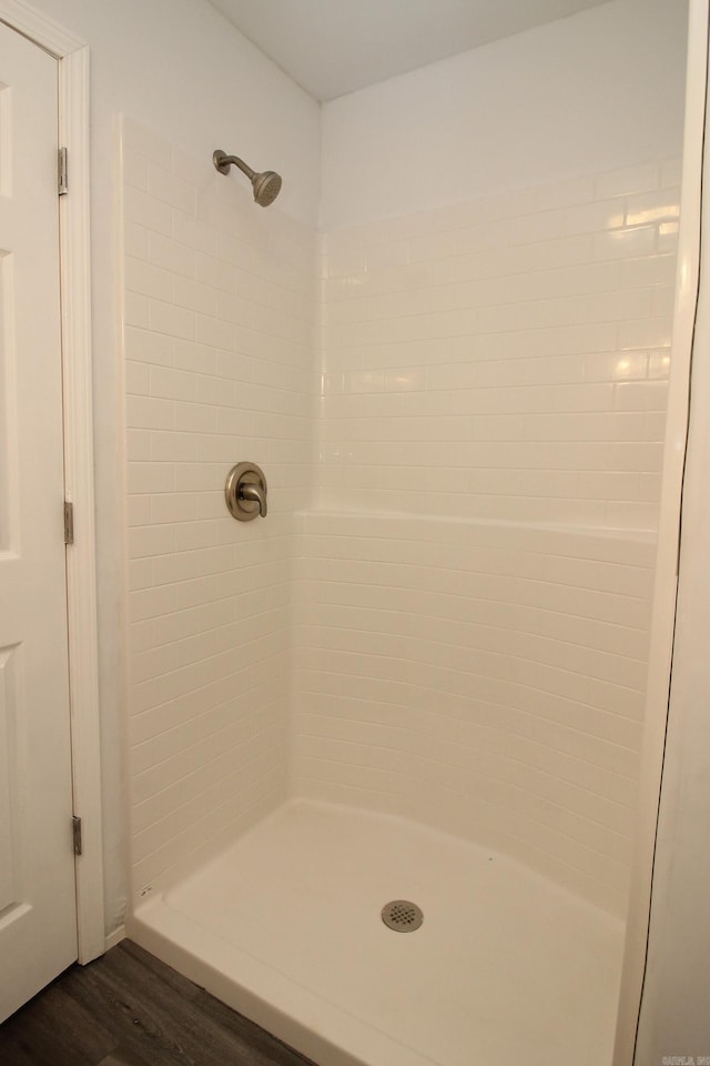 bathroom with a shower and hardwood / wood-style flooring