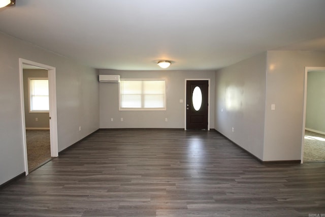 foyer with dark wood-type flooring and a wall mounted AC