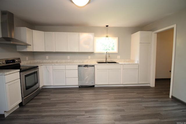 kitchen featuring stainless steel appliances, white cabinetry, wall chimney exhaust hood, and sink