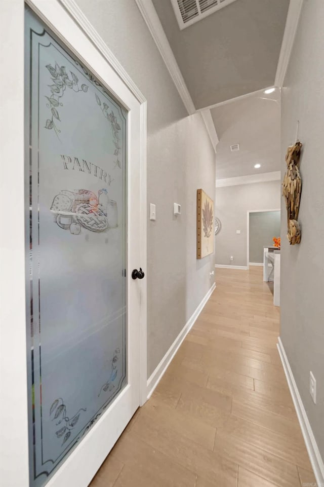 hallway featuring crown molding and light wood-type flooring