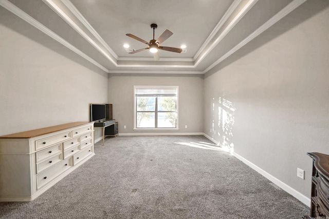 unfurnished living room featuring ceiling fan, ornamental molding, carpet floors, and a tray ceiling