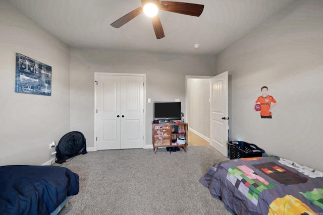 carpeted bedroom with ceiling fan and a closet