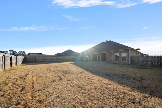 rear view of property featuring a lawn