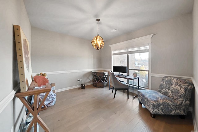 office area with a chandelier and light hardwood / wood-style flooring