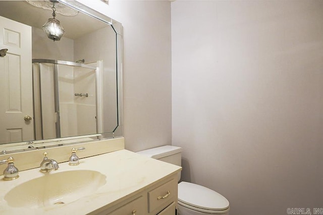 bathroom featuring vanity, toilet, and walk in shower