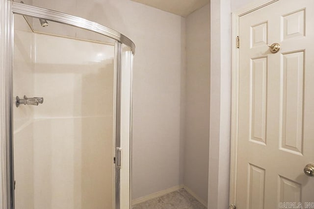 bathroom featuring a shower with door