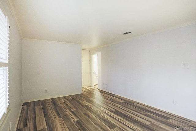 spare room with dark hardwood / wood-style floors and ornamental molding