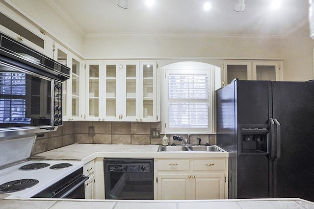 kitchen featuring black appliances, white cabinets, crown molding, sink, and decorative backsplash