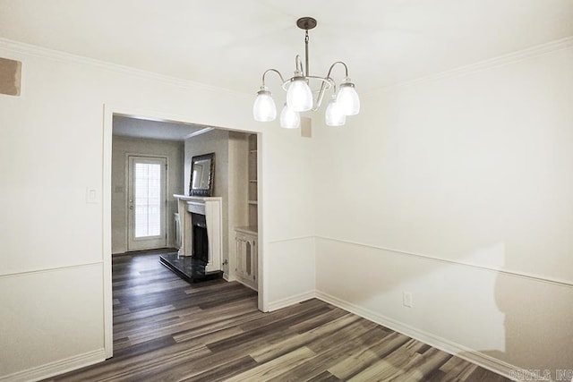 unfurnished dining area with crown molding, dark wood-type flooring, and an inviting chandelier