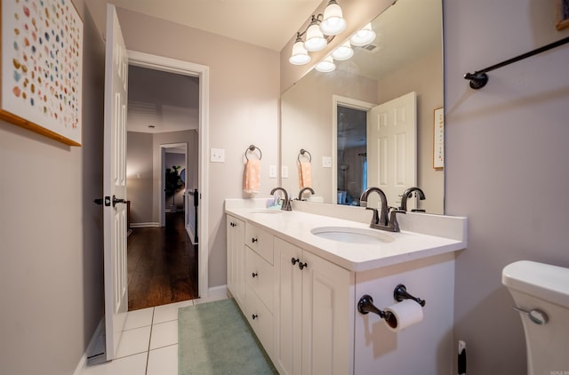 bathroom featuring tile patterned floors, vanity, and toilet