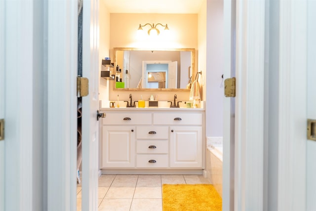 bathroom featuring tile patterned flooring, vanity, and a relaxing tiled tub