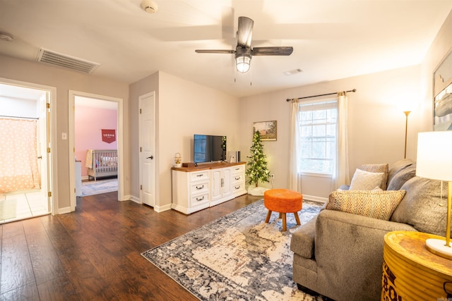 living room with dark hardwood / wood-style flooring and ceiling fan