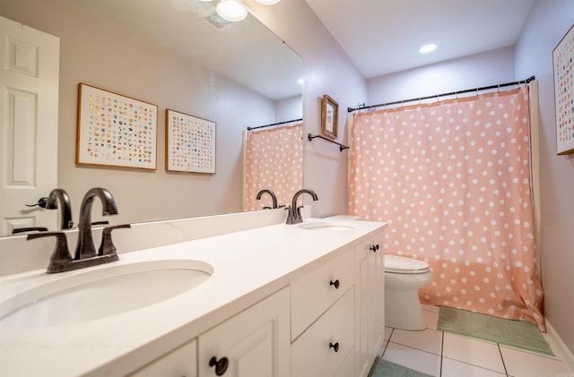 bathroom with toilet, a shower with curtain, vanity, and tile patterned floors