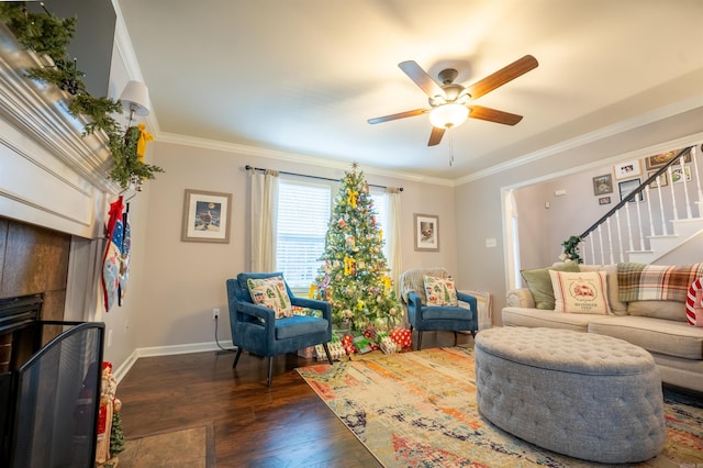 living area featuring ceiling fan, dark hardwood / wood-style flooring, and ornamental molding