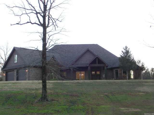 view of front of home with a garage and a front lawn