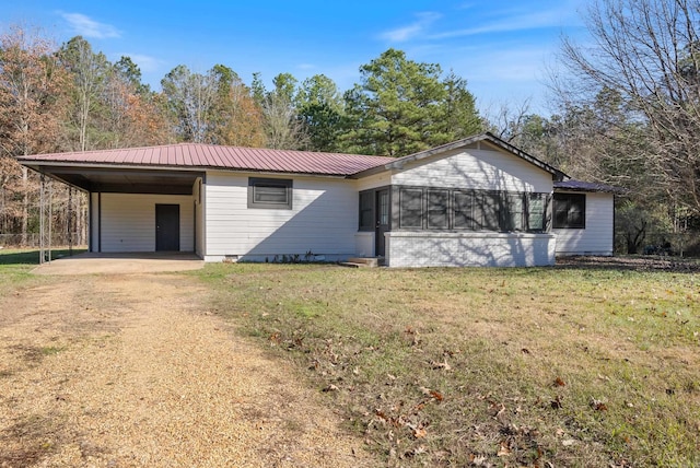 ranch-style house featuring a front yard and a carport